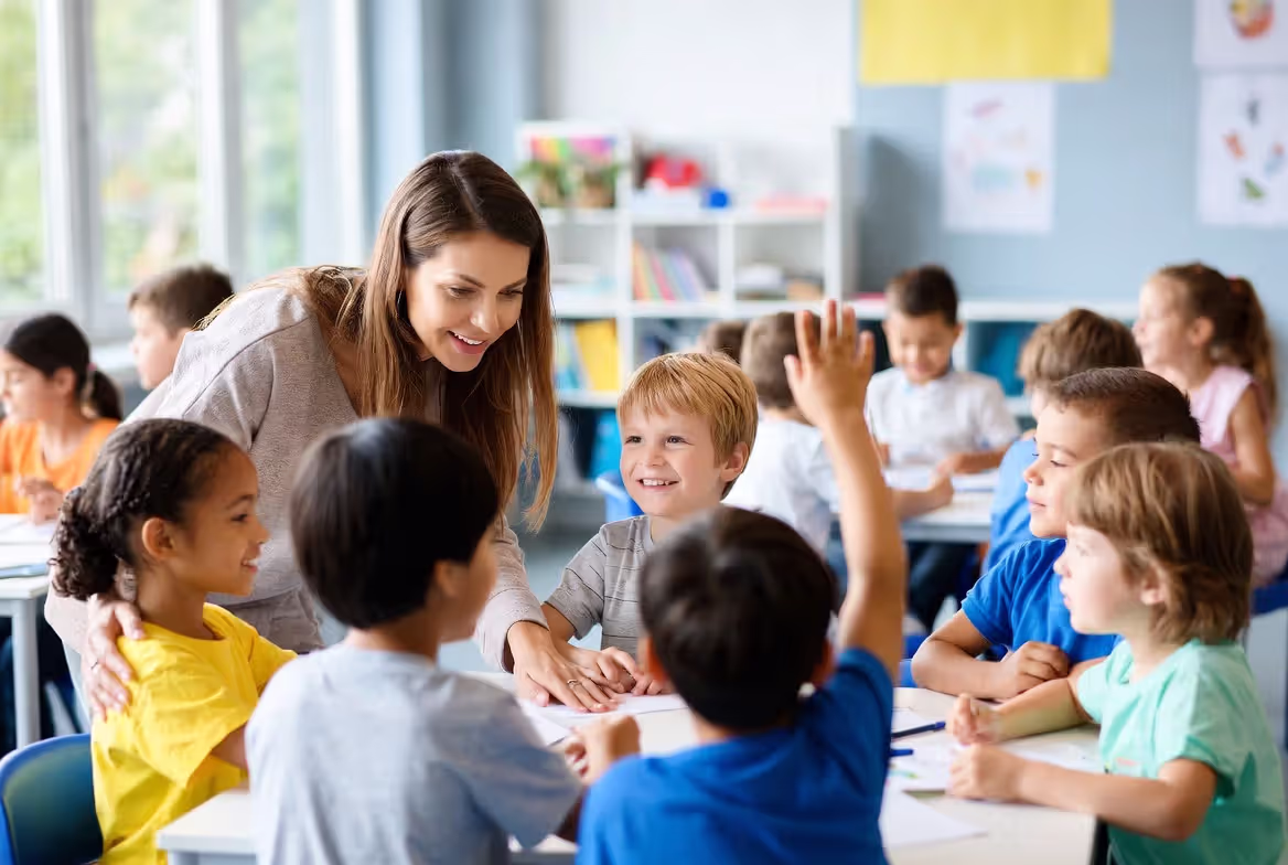 Teacher supporting students during classroom learning activity