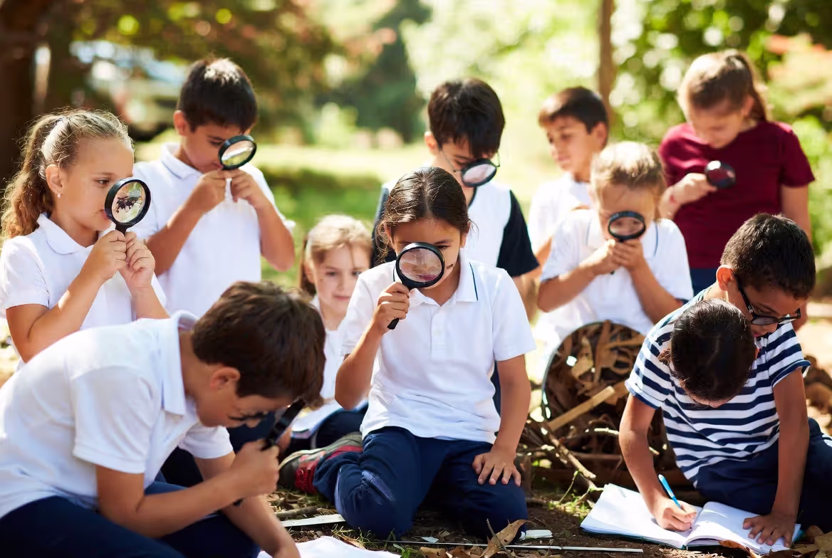 Elementary students participating in outdoor nature-based learning activity